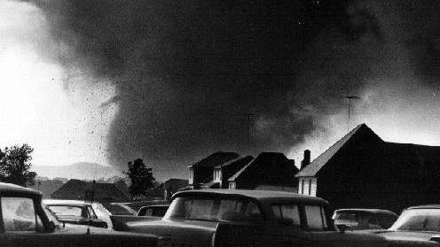 Historic Topeka tornado with massive funnel cloud under dark storm clouds, evoking the devastating 1966 storm and the power of Kansas weather.