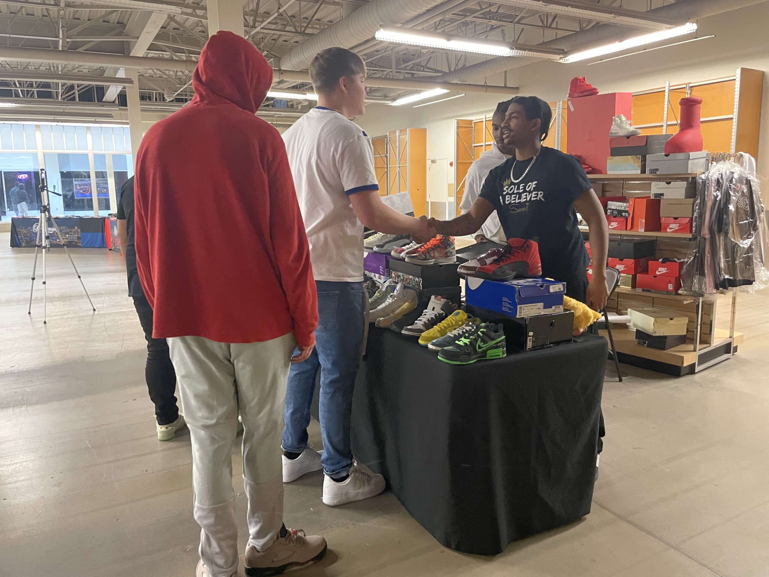 785 Sneaker Fest attendees browsing and shopping at vendor booths in West Ridge Mall, Topeka