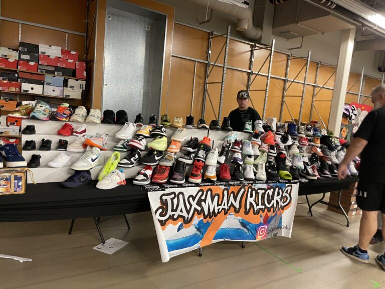 785 Sneaker Fest attendees browsing and shopping at vendor booths in West Ridge Mall, Topeka.