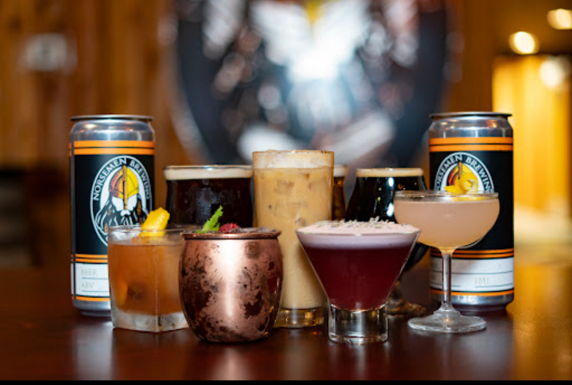 Assortment of Norsemen Brewing Company beers in unique glasses with Viking-inspired branding.