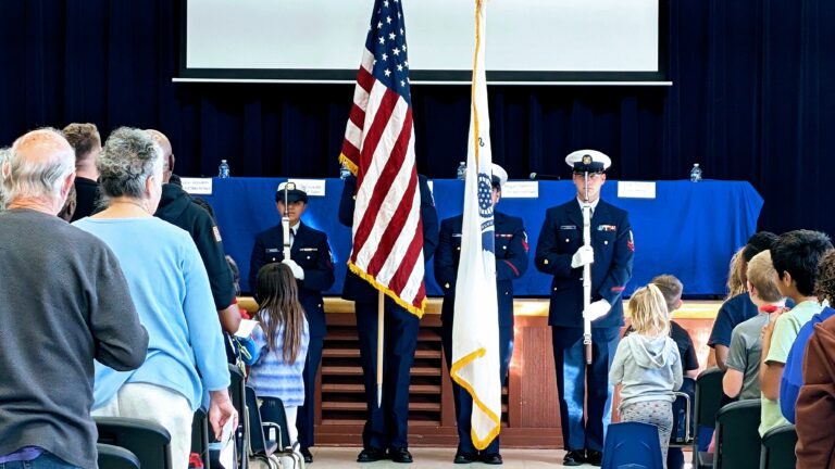 United States Coast Guard color guard in ceremonial uniform presenting the American flag, symbolizing patriotism and service