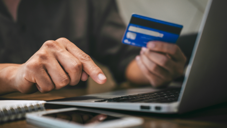 Person at a computer attempting to use someone else's credit card, symbolizing credit card fraud