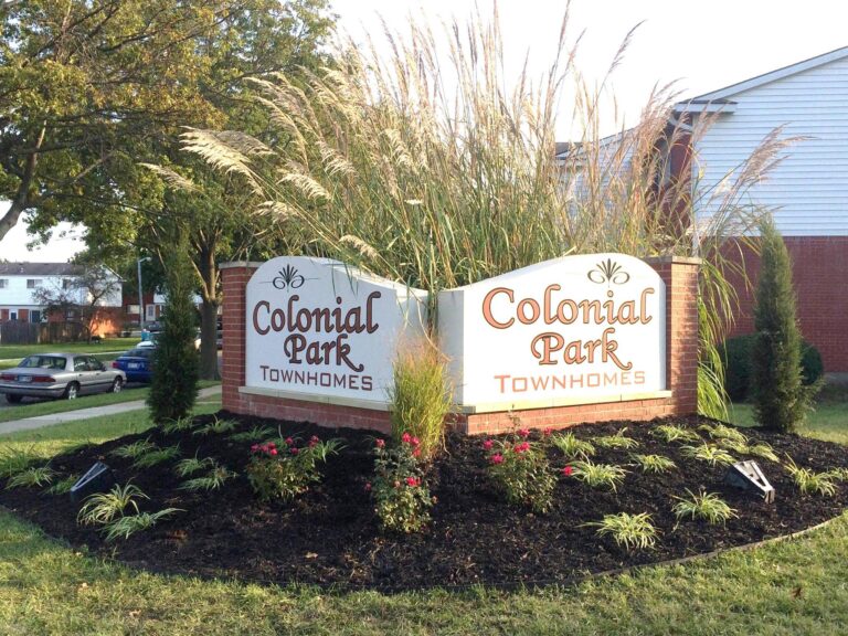 Colonial Park Townhomes entrance signage surrounded by landscaped greenery in Topeka, KS