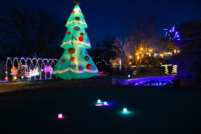 Corner 21 Sports Santa’s Village with glow-in-the-dark golf balls and festive Christmas lights at a mini-golf hole in Topeka, KS