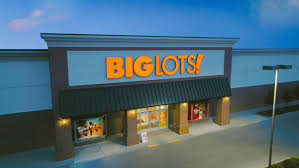 Big Lots store front in Topeka, Kansas, with a large sign and parking lot, captured during its final days before closure.