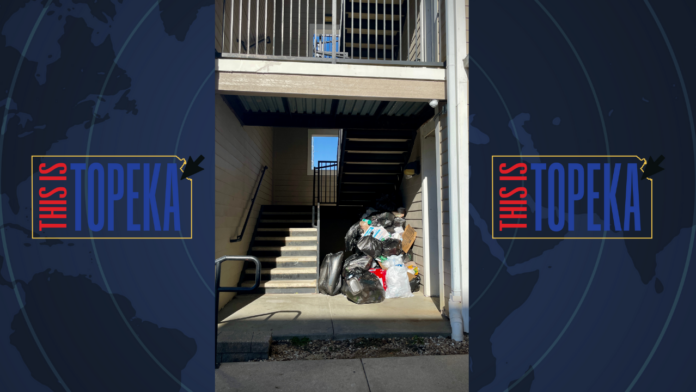 Overflowing garbage piled in an apartment stairwell, highlighting property maintenance issues.